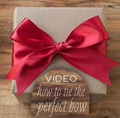 a present box with a red bow on it and the words video how to use the perfect bow