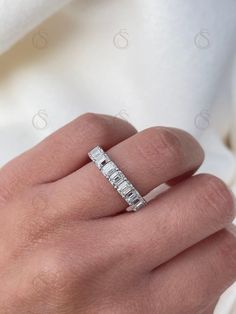 a woman's hand with a diamond ring on it