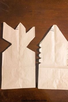 two pieces of paper are cut into the shape of a house and one piece is missing