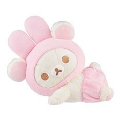 a small stuffed animal with a pink hat on it's head and legs, laying down