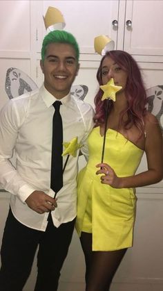 a man and woman dressed in costumes posing for the camera with stars on their heads