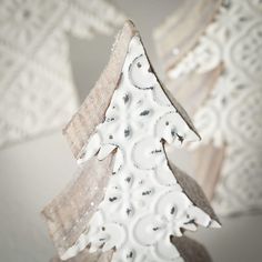 an ornament shaped like a christmas tree with snowflakes on it's sides