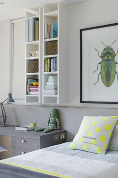 a bed sitting in a bedroom next to a book shelf