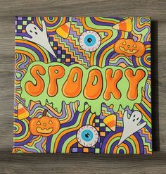 an art piece with the word spooky painted on it's front cover