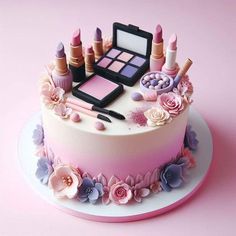 there is a cake that has makeup and lipsticks on it, with flowers around the edges