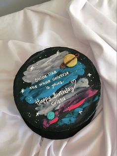 a birthday cake with an image of saturn and the moon on it's side