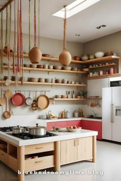 a kitchen with lots of pots and pans hanging from the ceiling over the stove