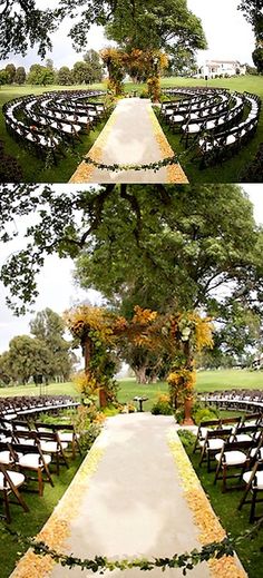 an outdoor ceremony set up with chairs and flowers on the aisle, surrounded by trees