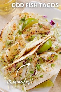 fish tacos on a plate with guacamole and salsa in the background