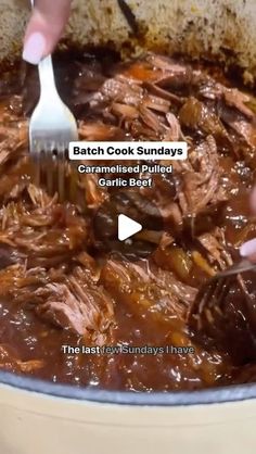 someone is using a fork to stir up some food in a pot with meat and gravy