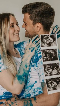 a man and woman hugging each other with their arms wrapped around them, both holding photos