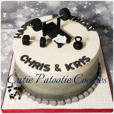 a birthday cake for a personal trainer with dumbbells and barbells on top