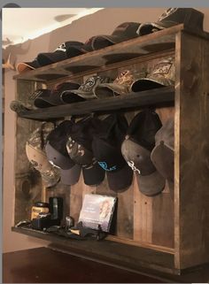 a wooden shelf filled with lots of hats