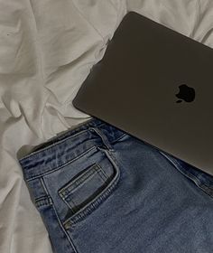 a minimalistic picture of a blue skirt and a space gray macbook pro on a white bedding. A Skirt, White Bedding, Electronic Devices, Blue Skirt, Macbook Pro