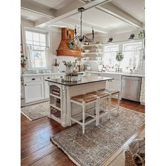 a large kitchen with an island in the middle and lots of counter space around it