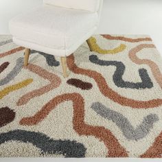 a white chair sitting on top of a shaggy rug