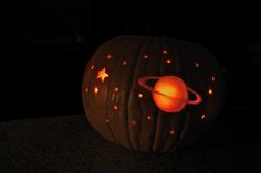 a pumpkin carved to look like saturn with stars on it