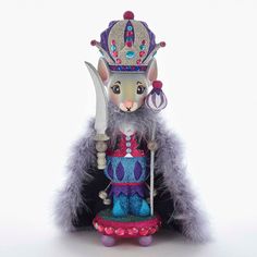 a cat figurine wearing a crown and holding a knife