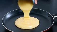 someone pouring sauce into a pan on the stove