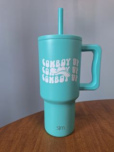 a blue cup sitting on top of a wooden table