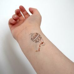 a person's arm with a small tattoo on it