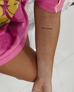 a woman's leg with the words let them tattoo on it