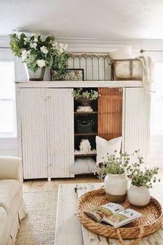 a living room filled with furniture and flowers