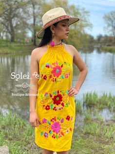 This Beautiful Halter Dress is the perfect Party dress. Its cute design and bold colors is the perfect combination, it also has elastic on the back for a tighter fit. The large florals are all hand embroidered which means the embroidered details vary On each dress, making them one of a kind. Purchase the earrings modeled here: https://www.etsy.com/es/listing/789091492/aretes-artesanales-pintado-a-mano-aretes?ref=listings_manager_grid Multicolor Mini Dress With Floral Embroidery For Summer, Multicolor Floral Embroidery Mini Dress For Summer, Fitted Yellow Dress With Floral Embroidery, Sleeveless Vacation Dresses With Embroidered Multicolor, Orange Embroidered Summer Dress, Summer Sleeveless Dress With Multicolor Embroidery, Summer Embroidered Mini Dress With Multicolor Embroidery, Multicolor Sleeveless Embroidered Dress For Beach, Multicolor Sleeveless Embroidered Dress For Summer