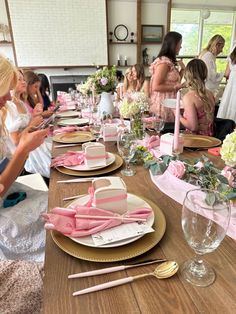 a group of women sitting at a table with plates and napkins