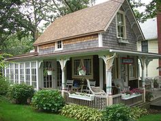 a small house with lots of windows and porches