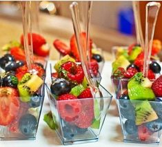 fruit salad in small glass containers with strawberries, kiwis, and grapes