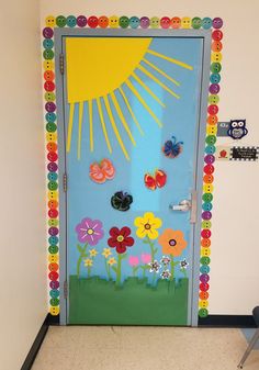 a door decorated with colorful flowers and sunbursts on the front entrance to a classroom