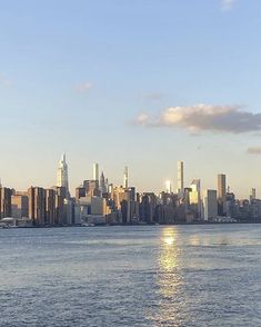 the city skyline is reflected in the water