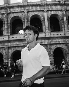 a man standing in front of an old building