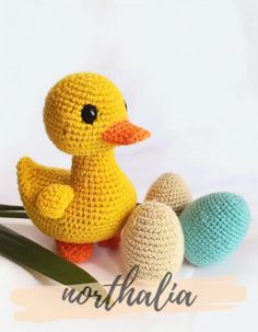 a crocheted yellow duck next to three eggs on a white background with the word australia written below it