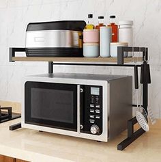 a microwave sitting on top of a counter next to a toaster oven and other kitchen items