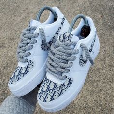 Have some fun and show off your unique sense of style with these Extra Lace Dioor Logo Custom Air Force 1 (AF1) sneakers. Featuring an additional lace design, these AF1s are perfect for making a statement. Rock them with any outfit to add a touch of personality and flair to your look.

Exactly as shown in the pictures. 📷
Brand New & Authentic. 💯
Hand Painted with attention to detail. 👨‍🎨
Waterproof and Flexible. ❤️
Unisex model. Please refer to the Size Chart. 👟👫
Free Worldwide Shipping. ✈️🌍 Trendy Custom Lace-up Sneakers, Trendy Custom High-top Sneakers, Designer Custom Sneakers For Streetwear, Trendy White Custom Sneakers With Laces, Designer High-top Custom Sneakers With Laces, White Sneakers For Streetwear With Lacing, White Sneakers With Lacing For Streetwear, White Lacing Sneakers For Streetwear, Trendy Custom Sneakers With Round Toe And Laces