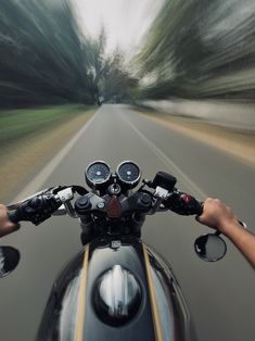 a person riding a motorcycle down a road