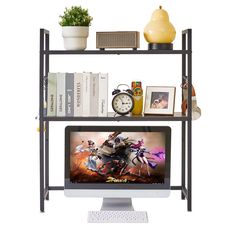 a computer monitor sitting on top of a metal shelf