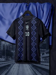 a soccer jersey hanging on a hanger in front of a blue and black background