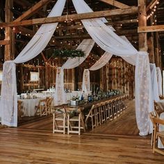 the inside of a barn decorated for a wedding