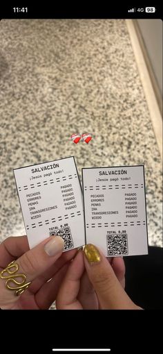 someone is holding two tickets in their hand