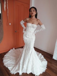 a woman in a white wedding dress posing for the camera