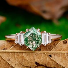 a close up of a ring on top of a leaf