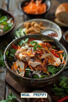 a bowl filled with meat and vegetables on top of a wooden table next to other bowls