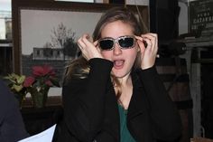 a woman wearing sunglasses making a funny face