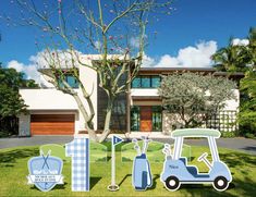 golf themed yard decorations in front of a house with trees and lawn mowers