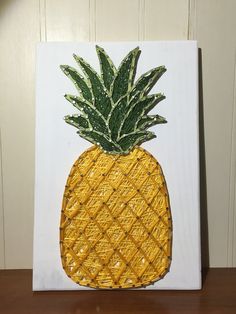 a painting of a pineapple on a white canvas