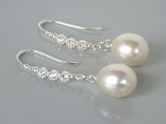 A stunning and elegant pair of dangle hook earring.  Approximately 10.5mm x 9.5mm half drilled white drop pearls with very good lustre. AAA quality freshwater pearls and Sterling silver hooks with cubic zirconia setting.  The earrings is approximately 3.8cm long.  The pearls are genuine freshwater pearls therefore each pearl is slightly different in shape and size with it own unique natural blemishes. The colour of the actual earrings might be slightly different to the photo due to the lighting Silver Pearl Earrings With French Hook For Formal Occasions, Silver Pearl Earrings With French Hook For Formal Events, Elegant Sterling Silver Pearl Earrings With Ear Wire, Elegant Silver Pearl Earrings With French Hook, Elegant Pearl Earrings With French Hook For Gift, Elegant Pearl Earrings With French Hook, Elegant Jewelry With French Hook For Anniversary, Elegant White Jewelry With French Hook, Elegant Pearl Earrings With French Hook For Wedding