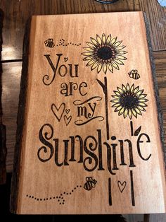 a wooden plaque with the words you are my sunshine and sunflowers on it